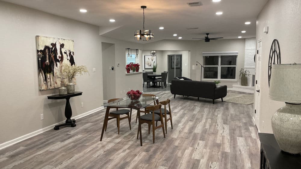 Modern living room and dining area with neutral tones, wooden flooring, and chic decor.